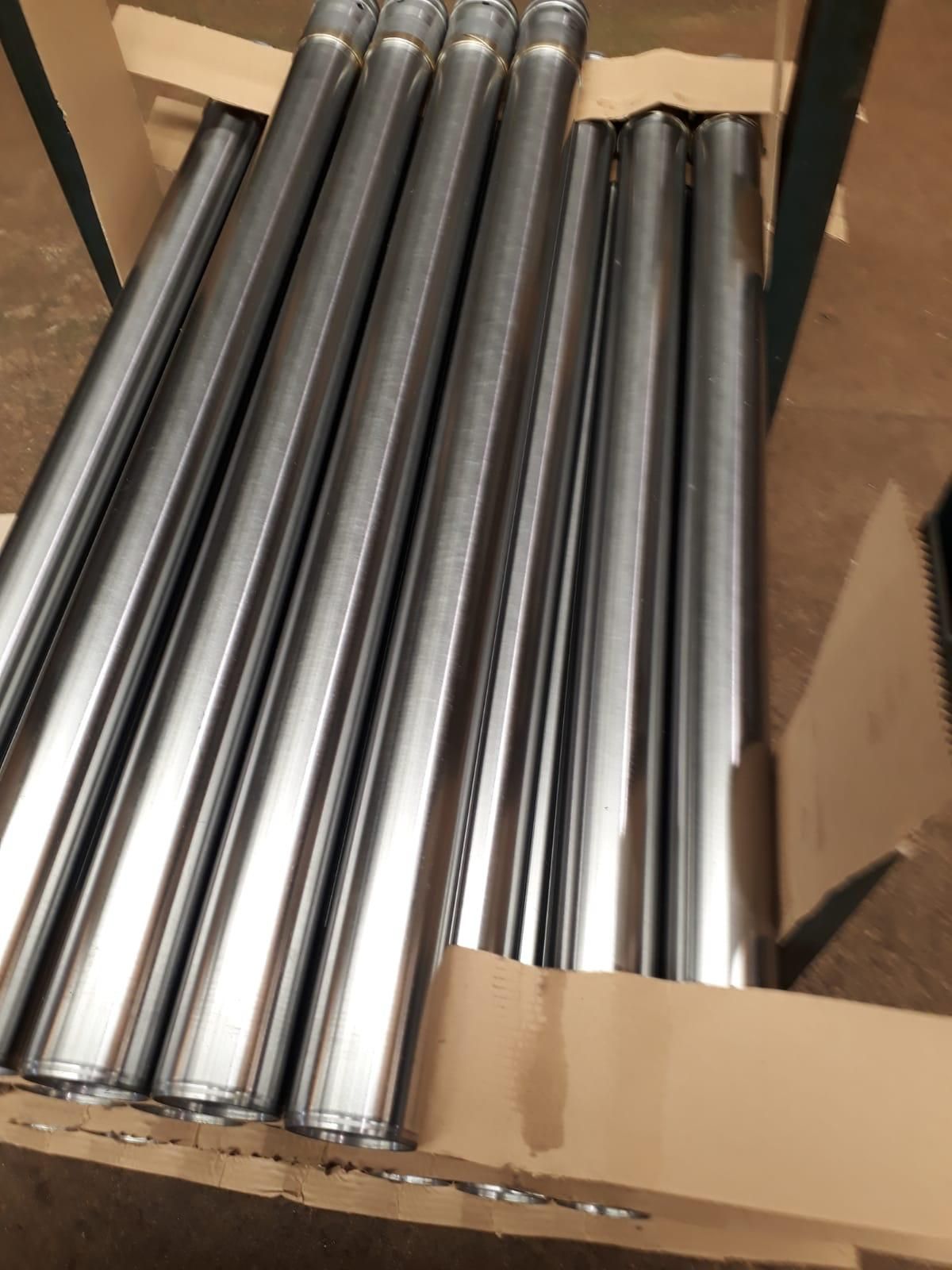 Una caja de cartón llena de tubos de acero inoxidable