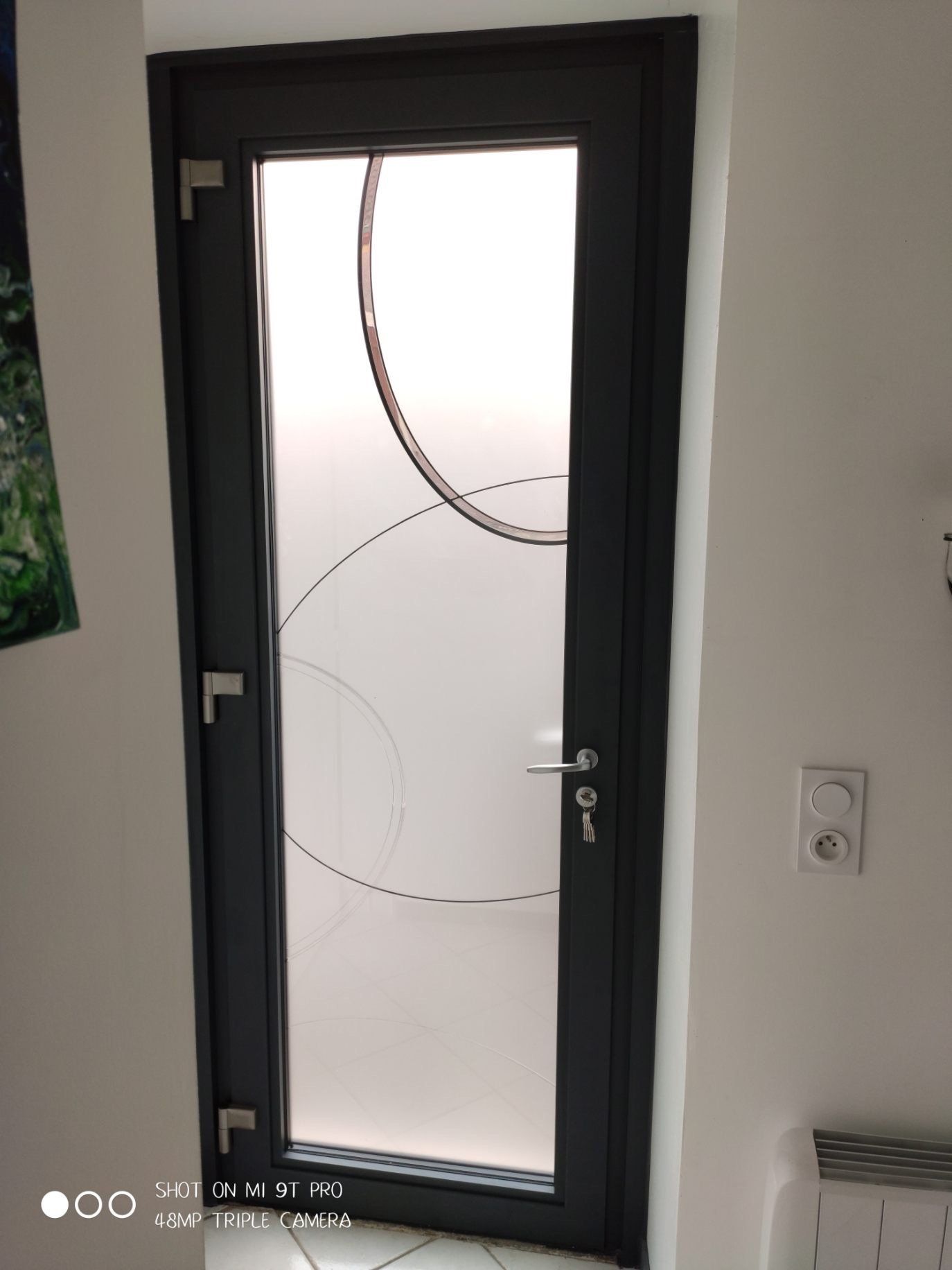 Porte d'entrée vitrée vue de l'intérieur