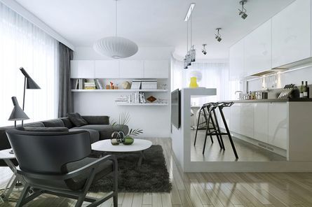 Espacio moderno de concepto abierto con gabinetes blancos, asientos negros y pisos de madera. Incluye cocina y sala de estar.