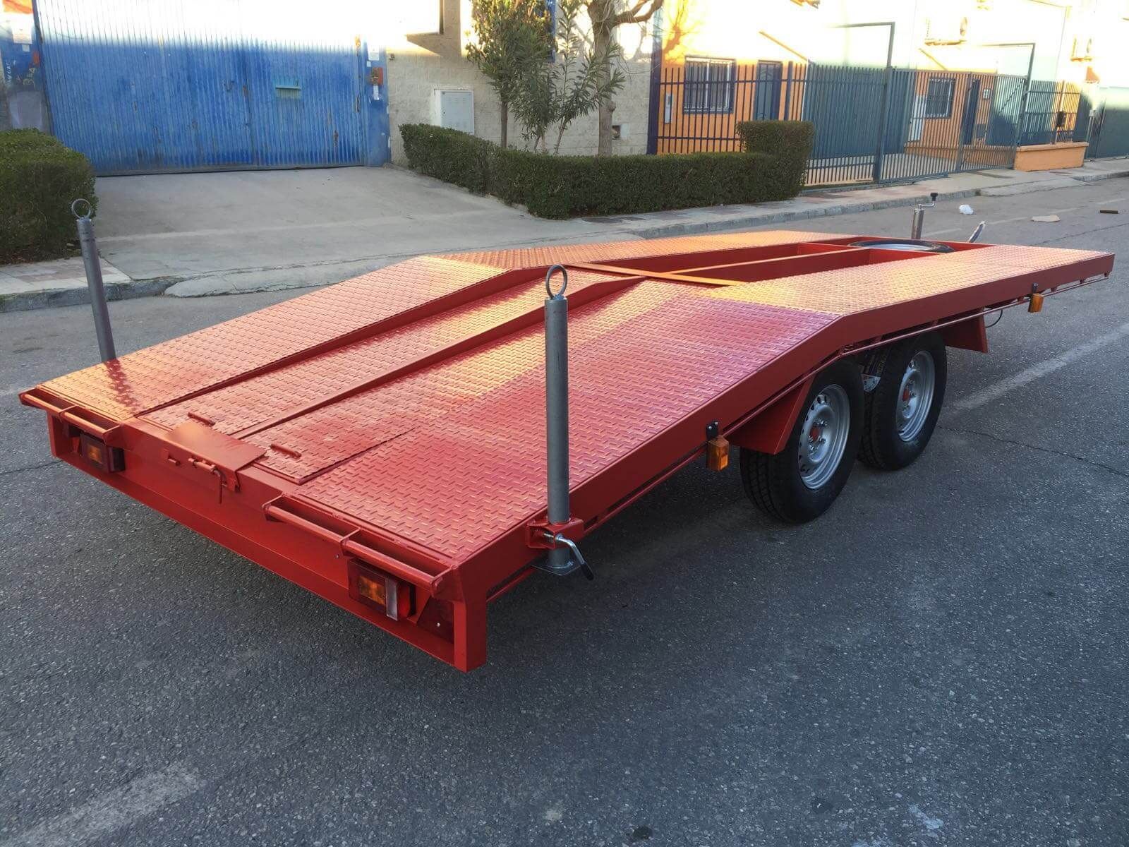 Un remolque rojo está estacionado al costado de la carretera.