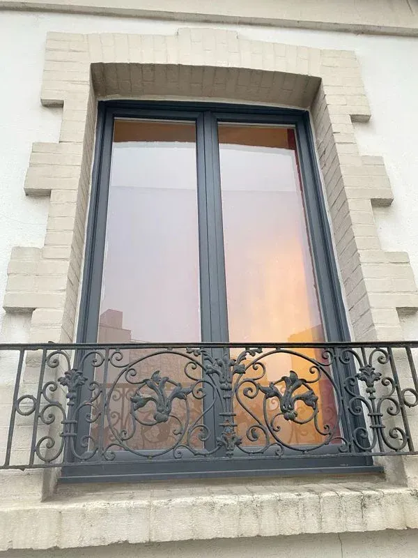 Fenêtre grise avec garde-corps devant