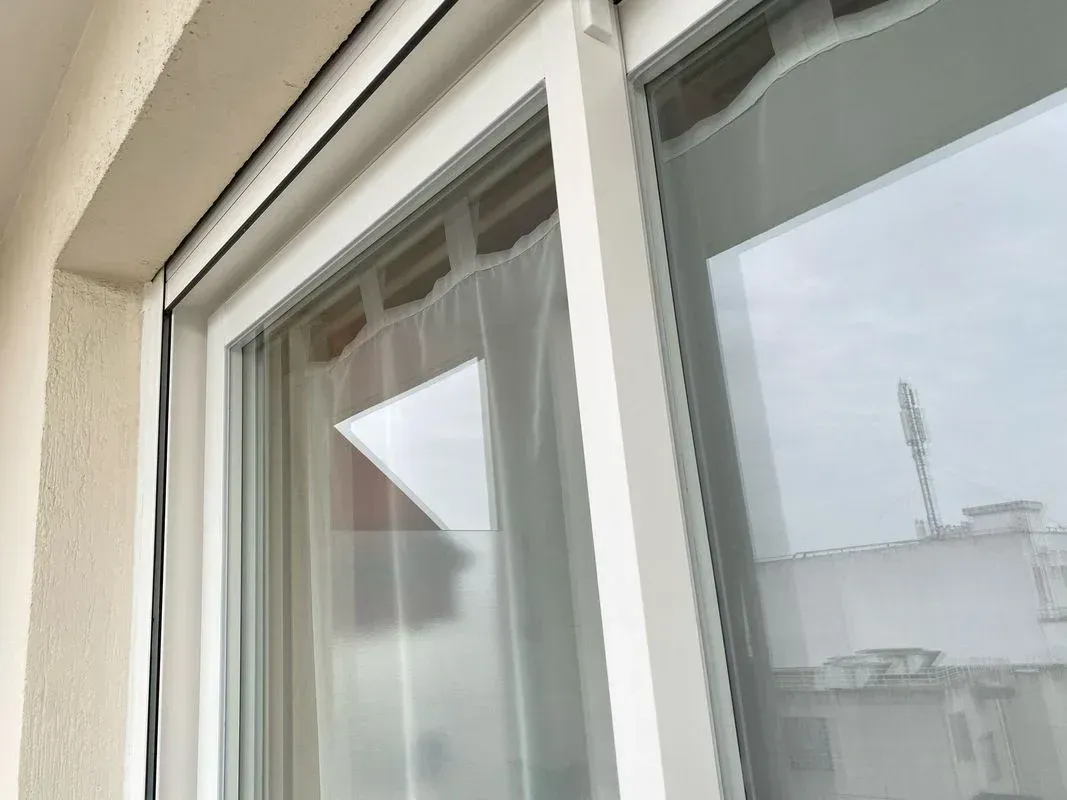 Baie vitrée avec des rideaux blancs