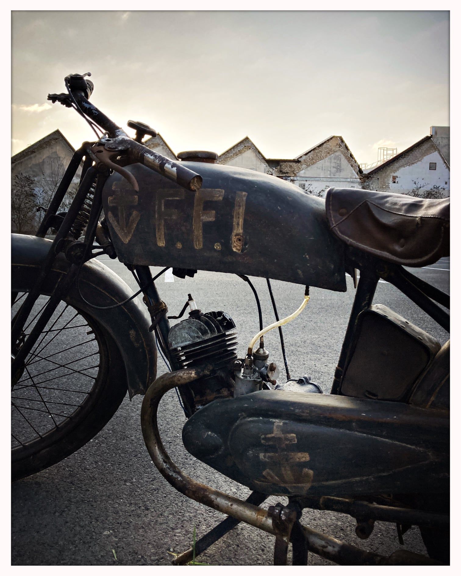 Vieille moto noire avec l'inscription FFI garée devant les locaux de Châtivesle Maison de ventes.