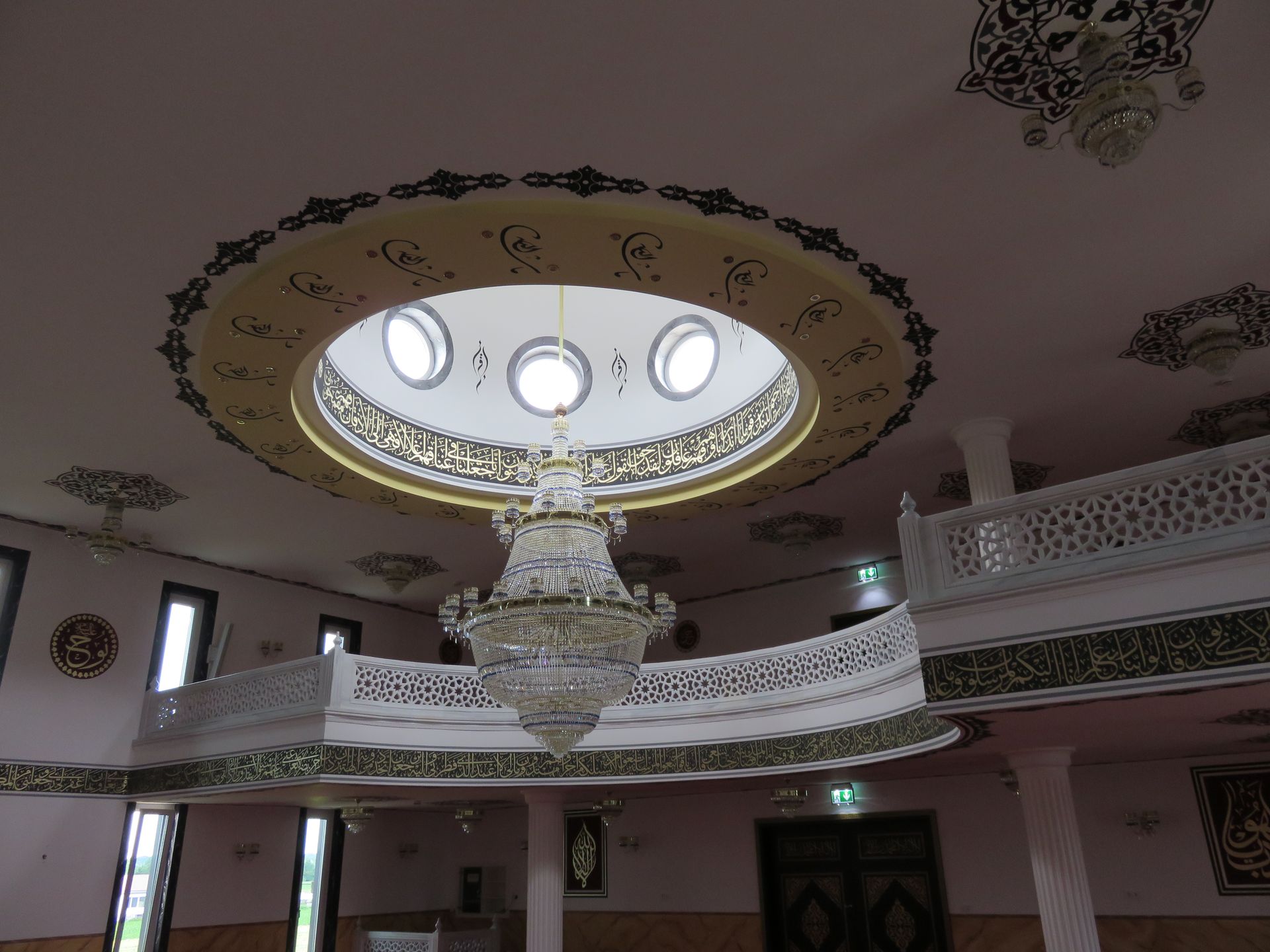 Innenraum mit Kuppel, Kronleuchter und islamischen Ornamenten in der Moschee Deggendorf