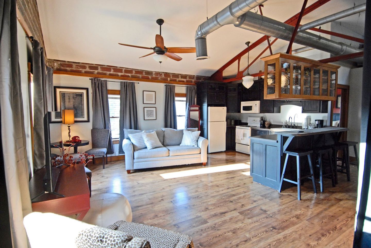 A living room with a couch and a ceiling fan