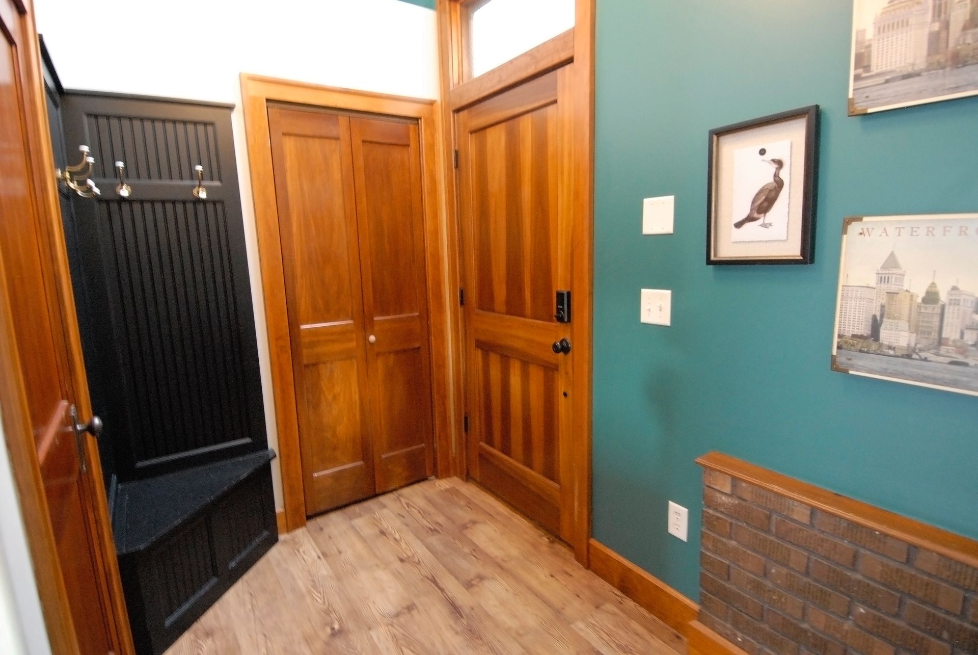 A hallway with a picture of a bird on the wall