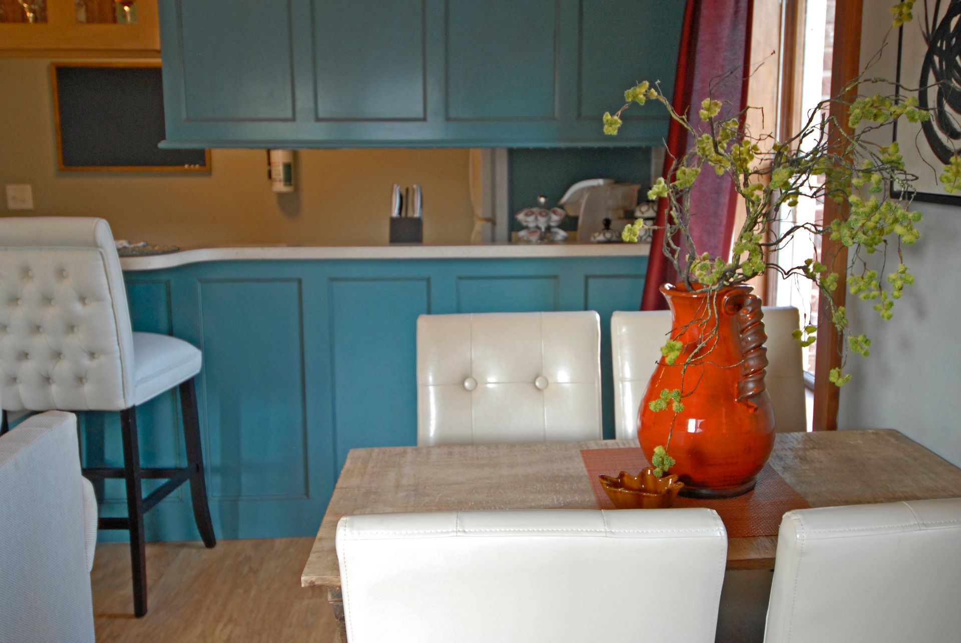 A dining room table with a vase of flowers on it