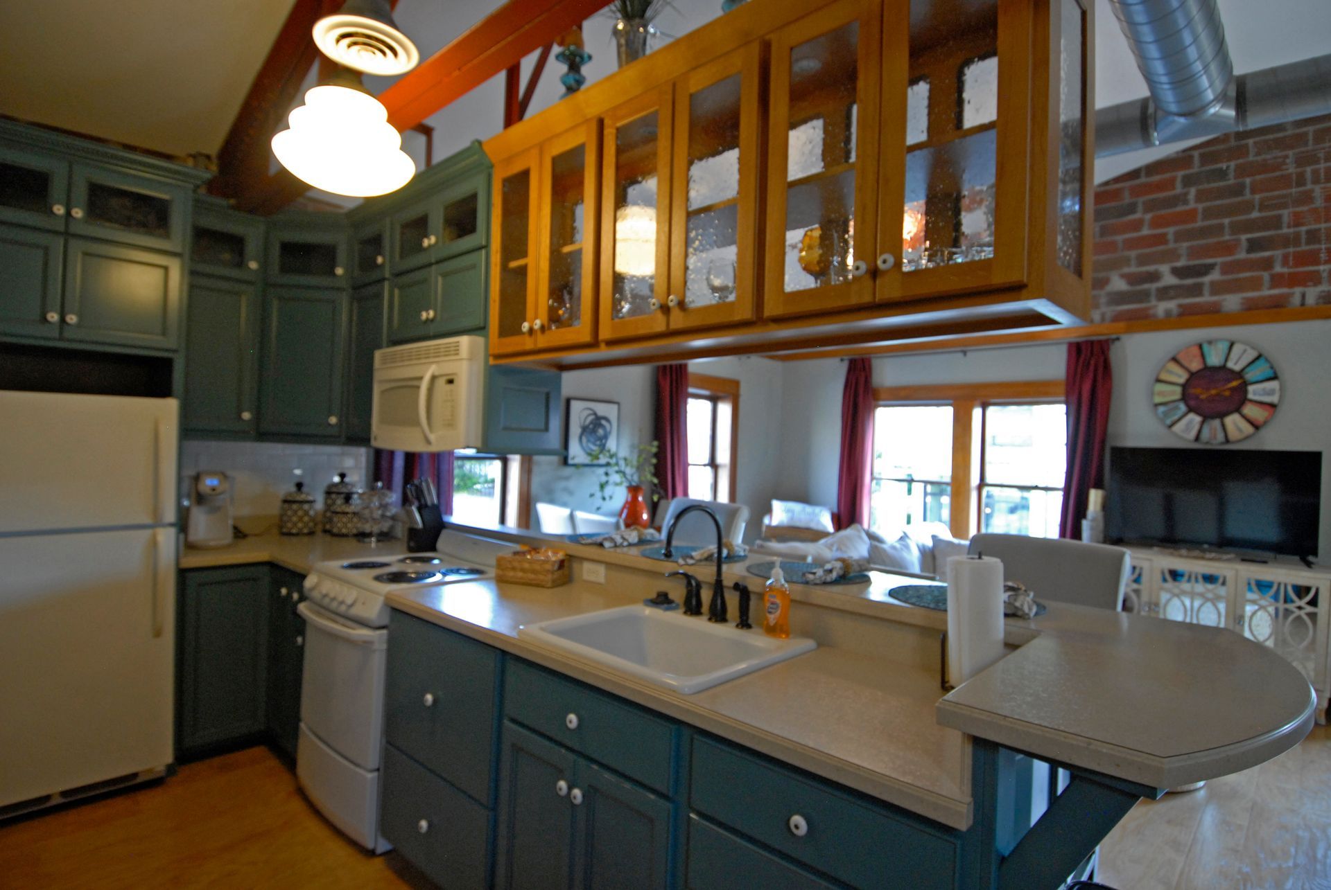 A kitchen with blue cabinets and a white refrigerator