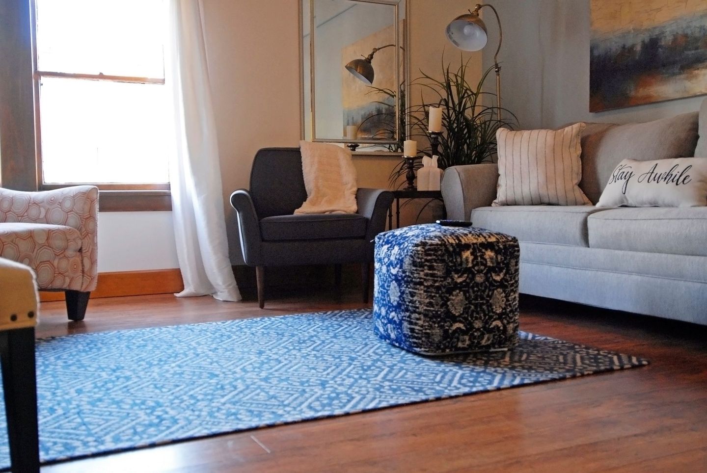 A living room with a couch and two chairs