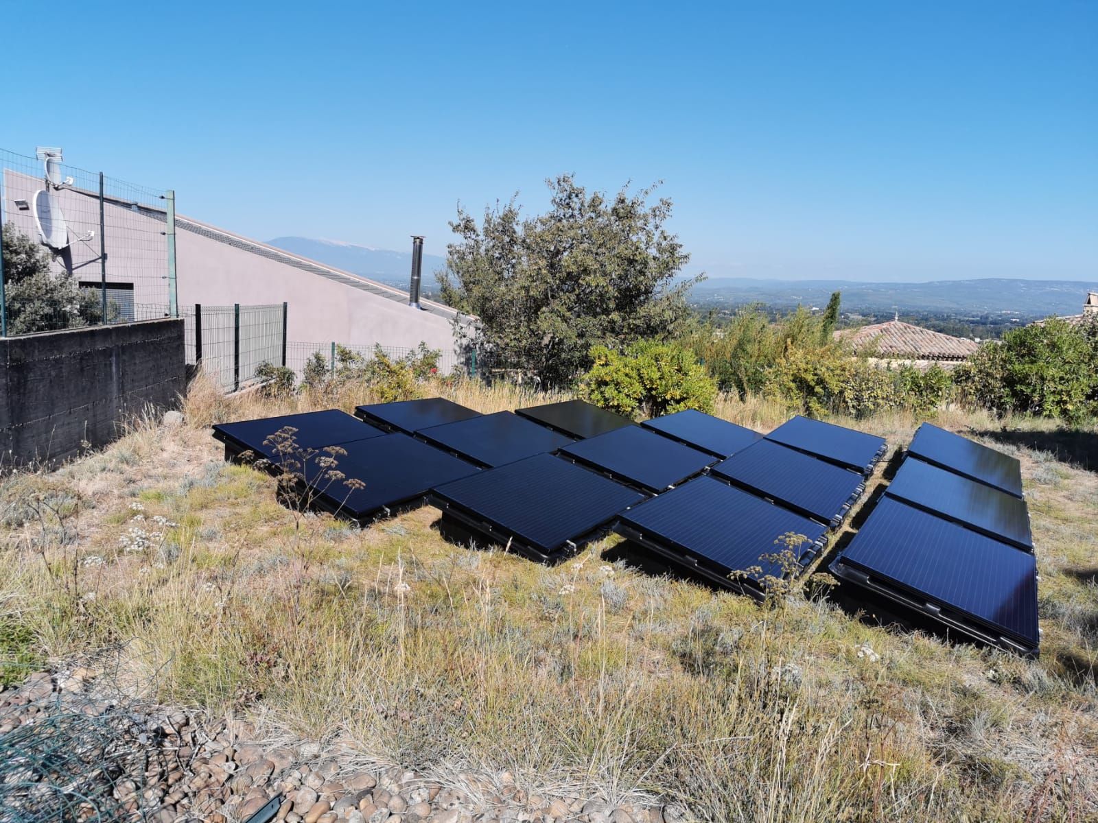 Installation de panneaux solaires au sol dans une parcelle de particulier.