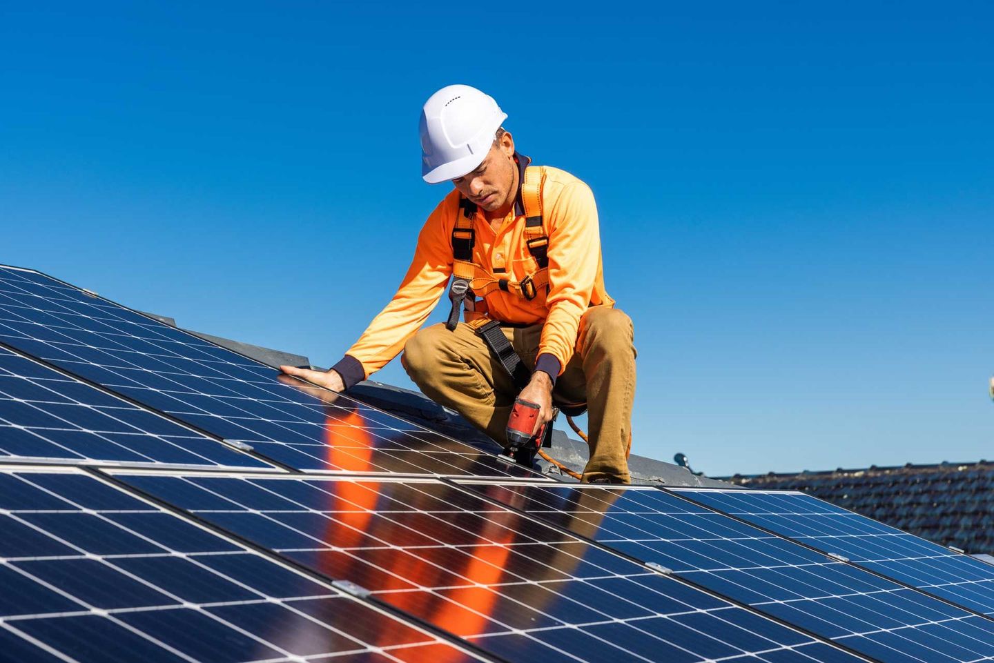 Un technicien fixant un panneau solaire.
