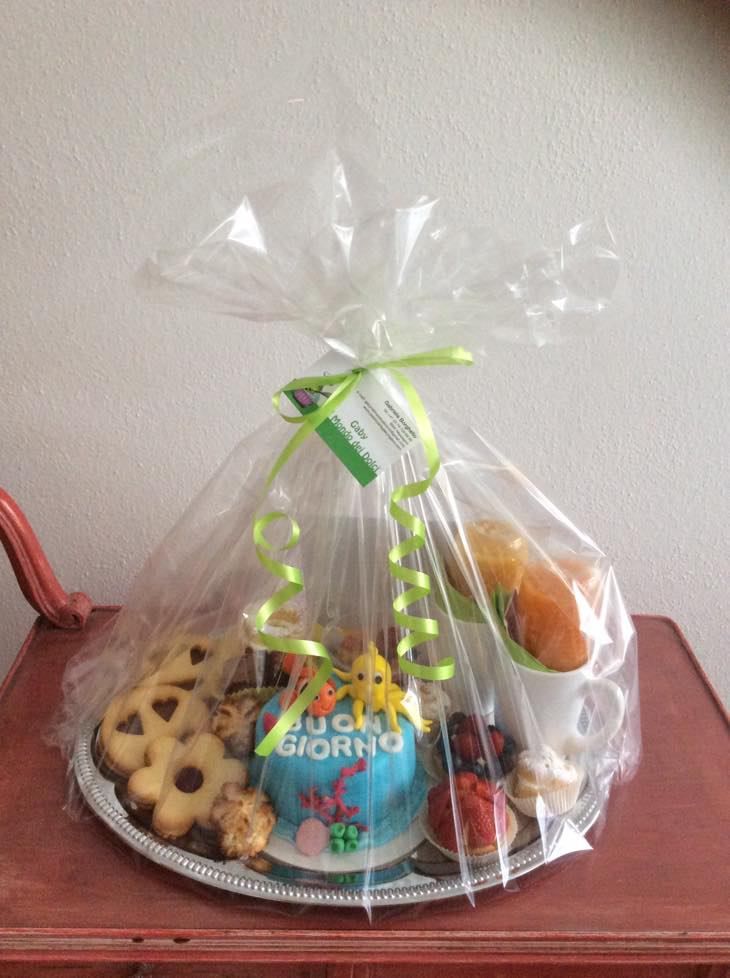 Su un tavolo c'è un vassoio di cibo avvolto nella plastica.