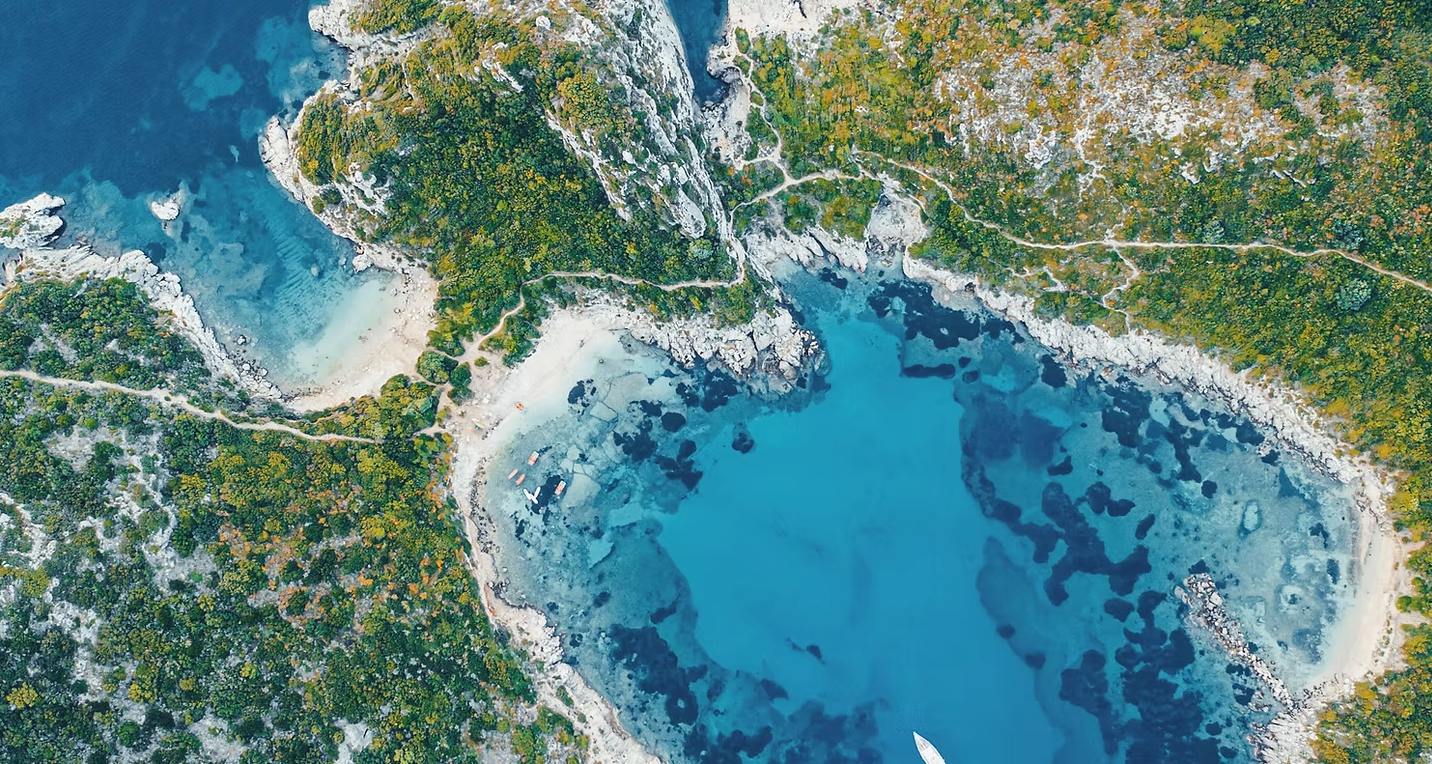An aerial view of a large body of water surrounded by trees.