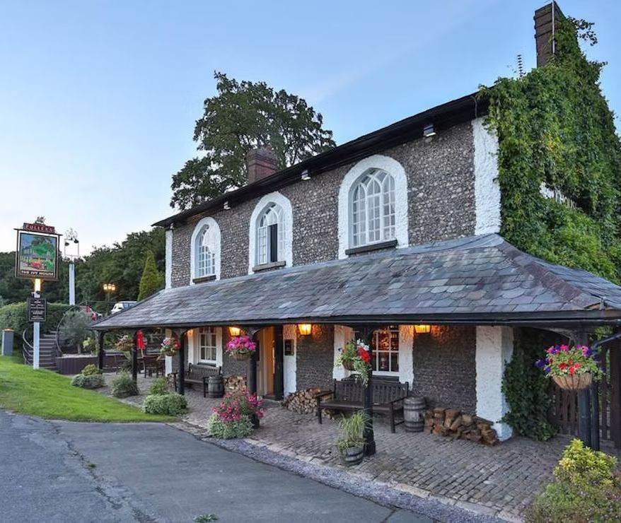 A large stone building with arched windows and a slate roof