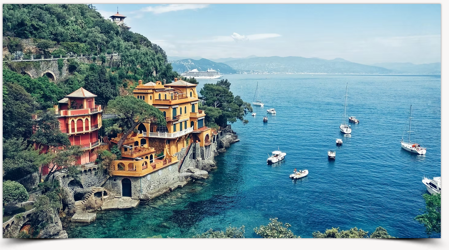 A cliff overlooking a body of water with boats in it.