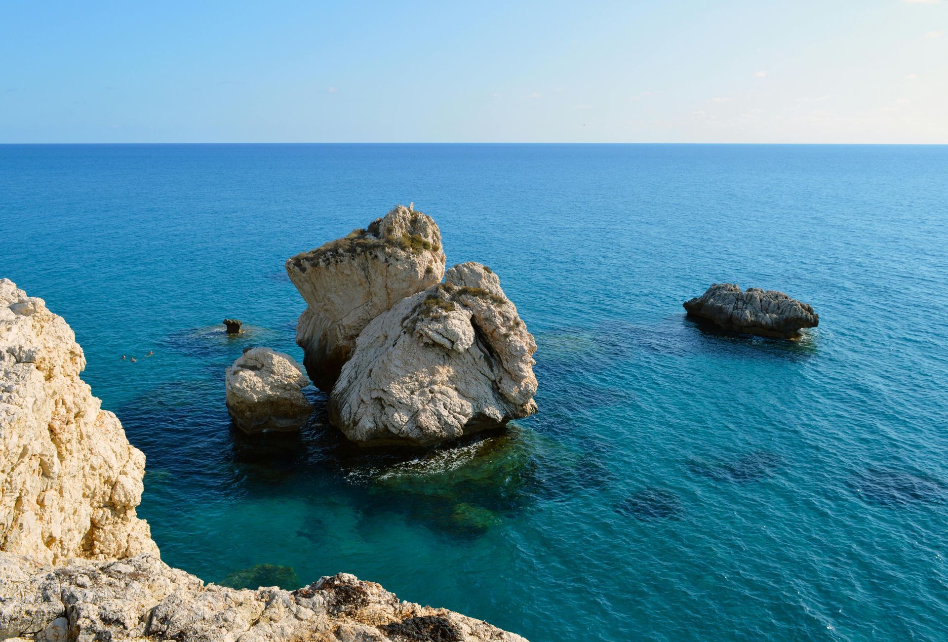 A group of rocks in the middle of the ocean.