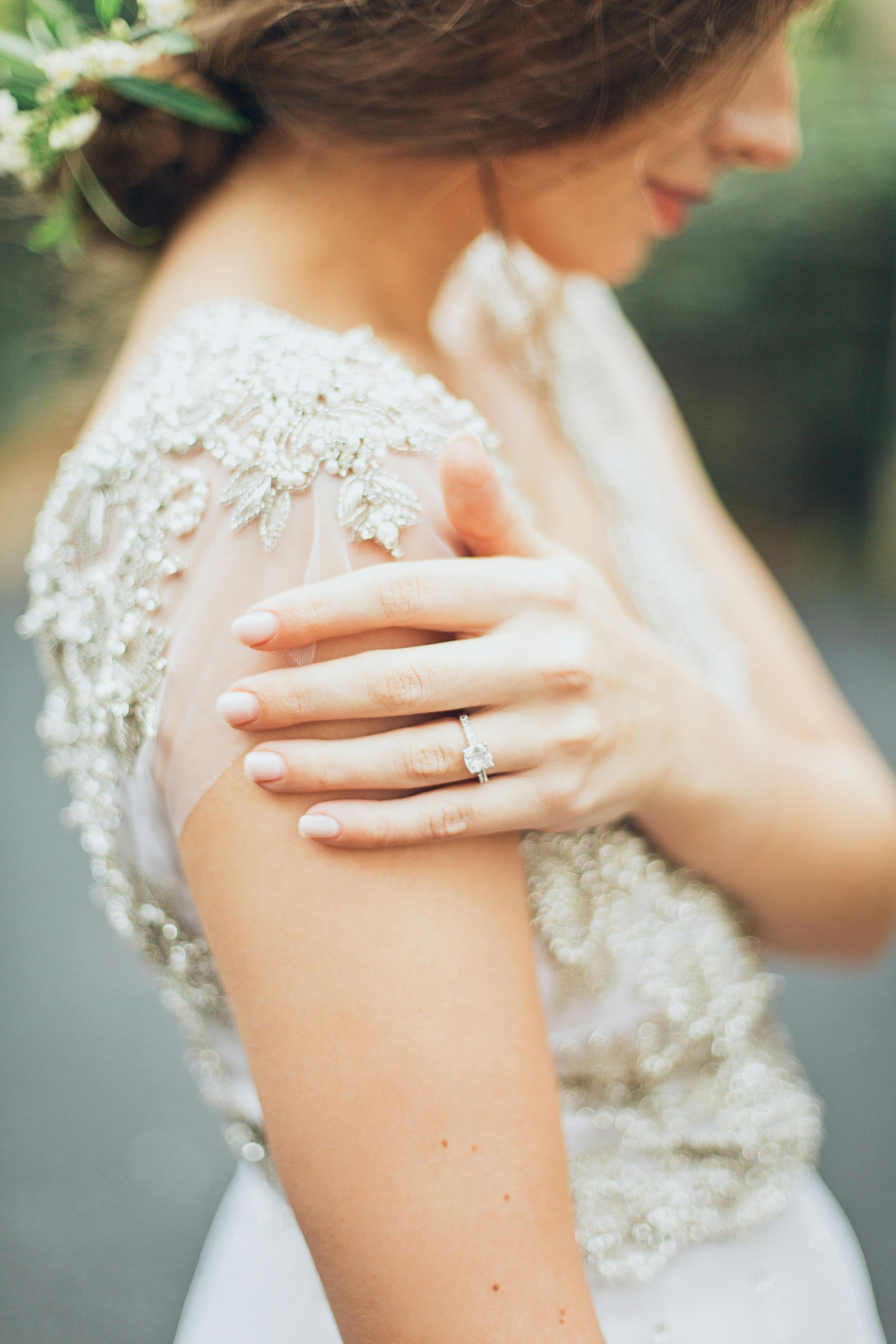 The bride is wearing a wedding ring on her finger.