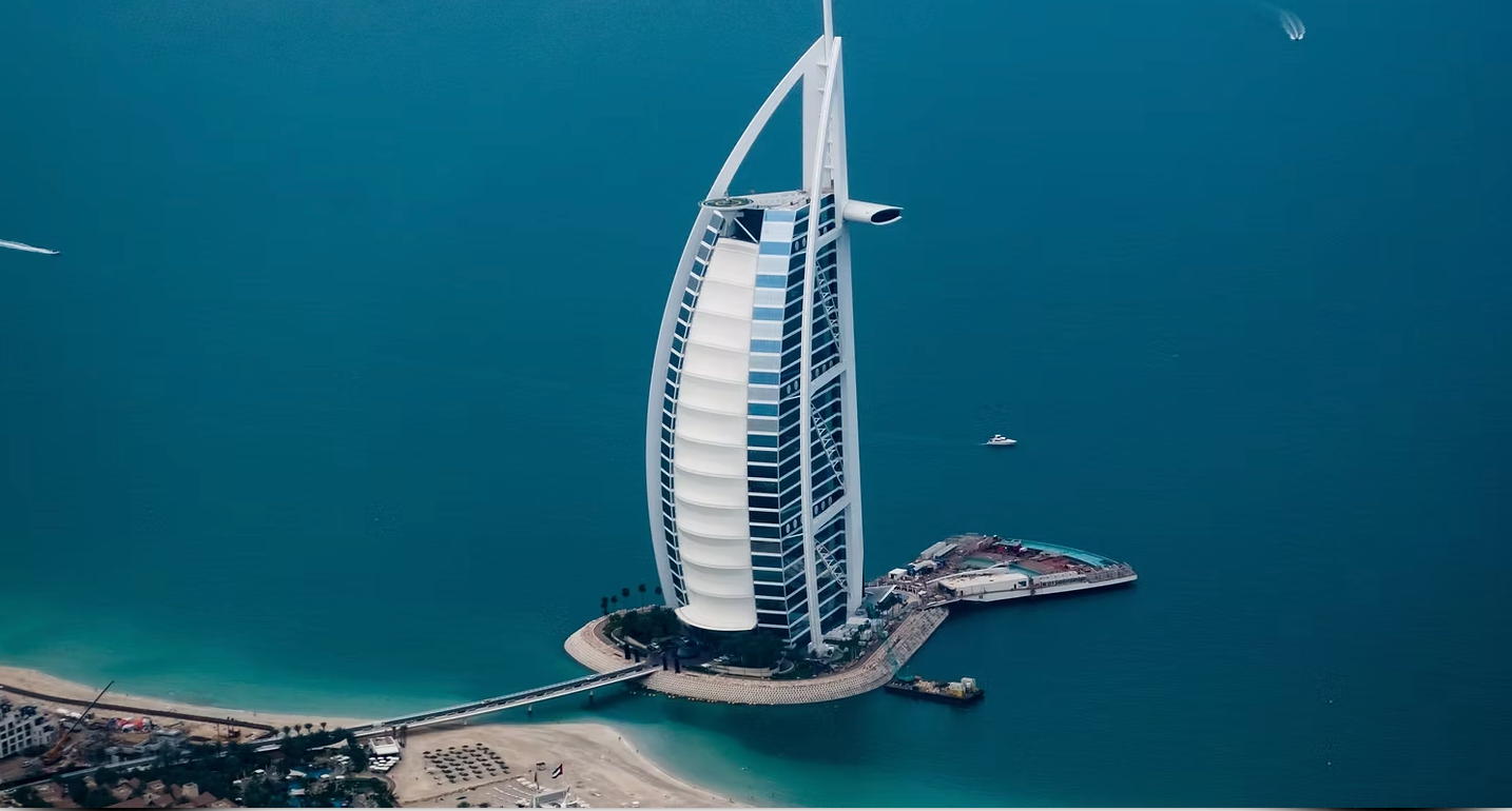 An aerial view of a large building in the middle of the ocean.