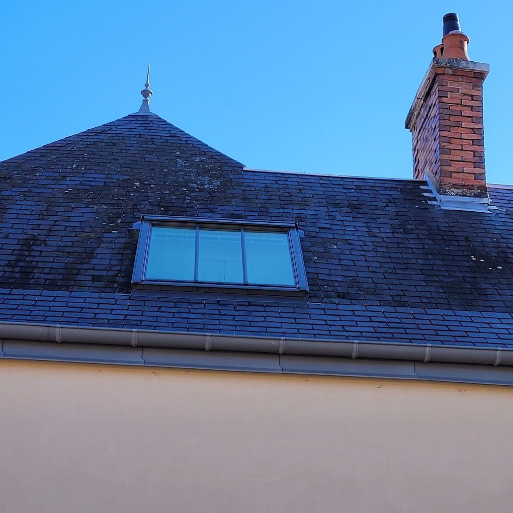 Grande fenêtre de toit sur une toiture en ardoise