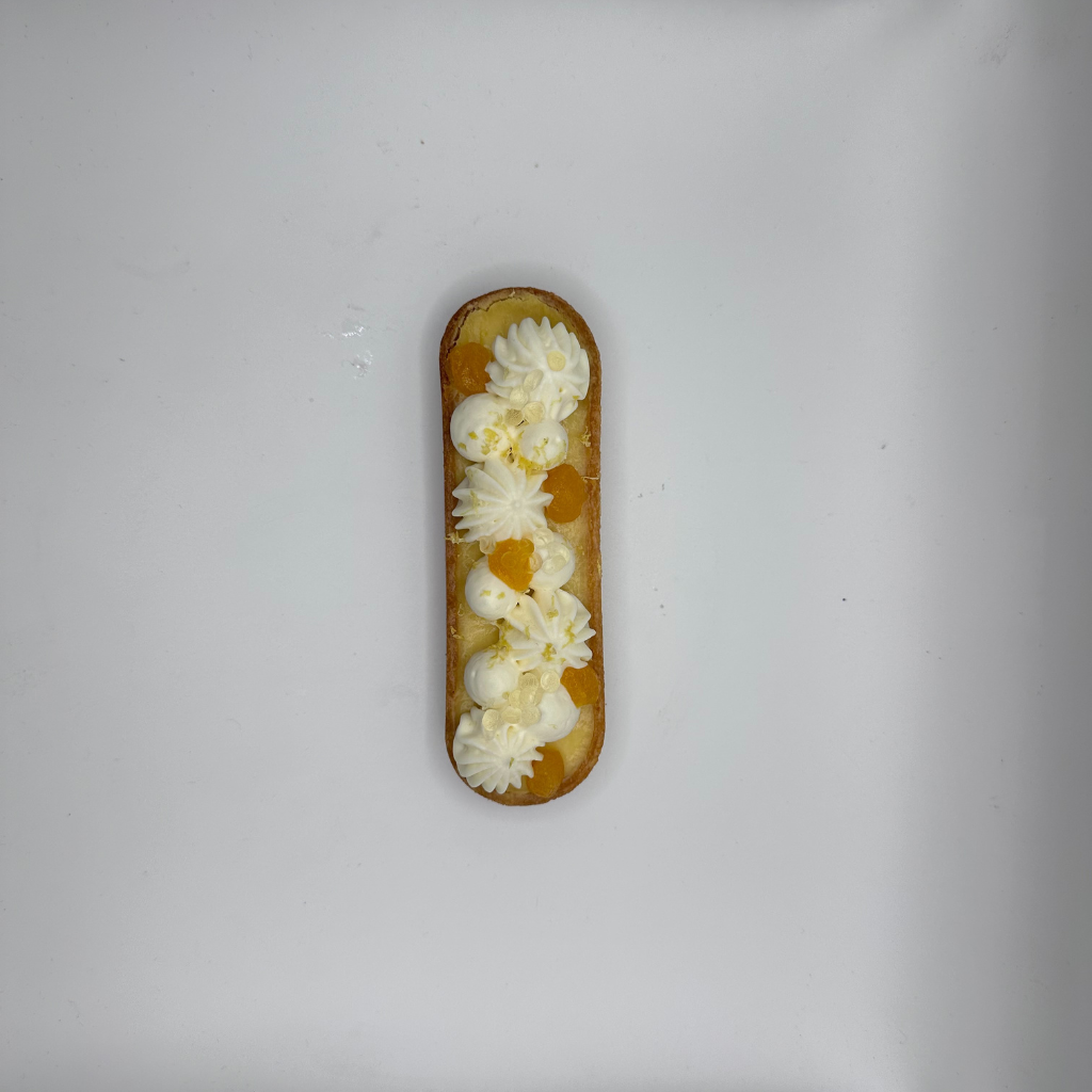 Une pâtisserie aux figues et aux cerises sur une assiette blanche