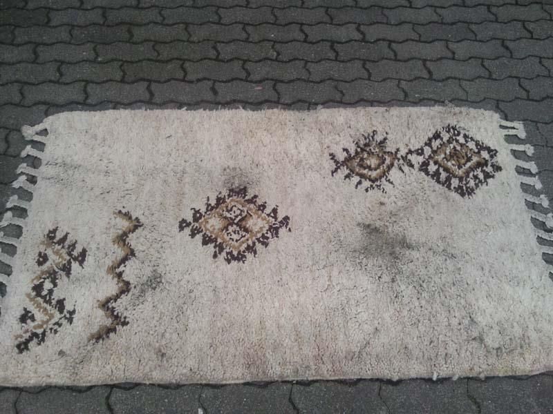 Ein Teppich liegt auf dem Boden auf einem gemauerten Gehweg