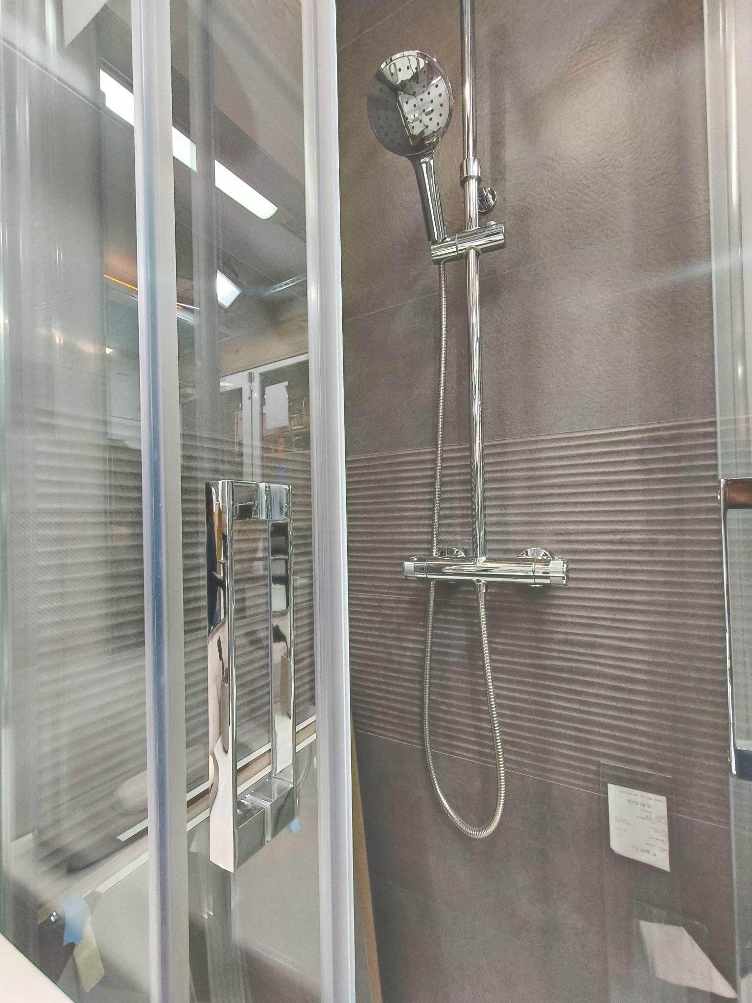 Una ducha con un cabezal de ducha y una cortina de ducha en un baño.