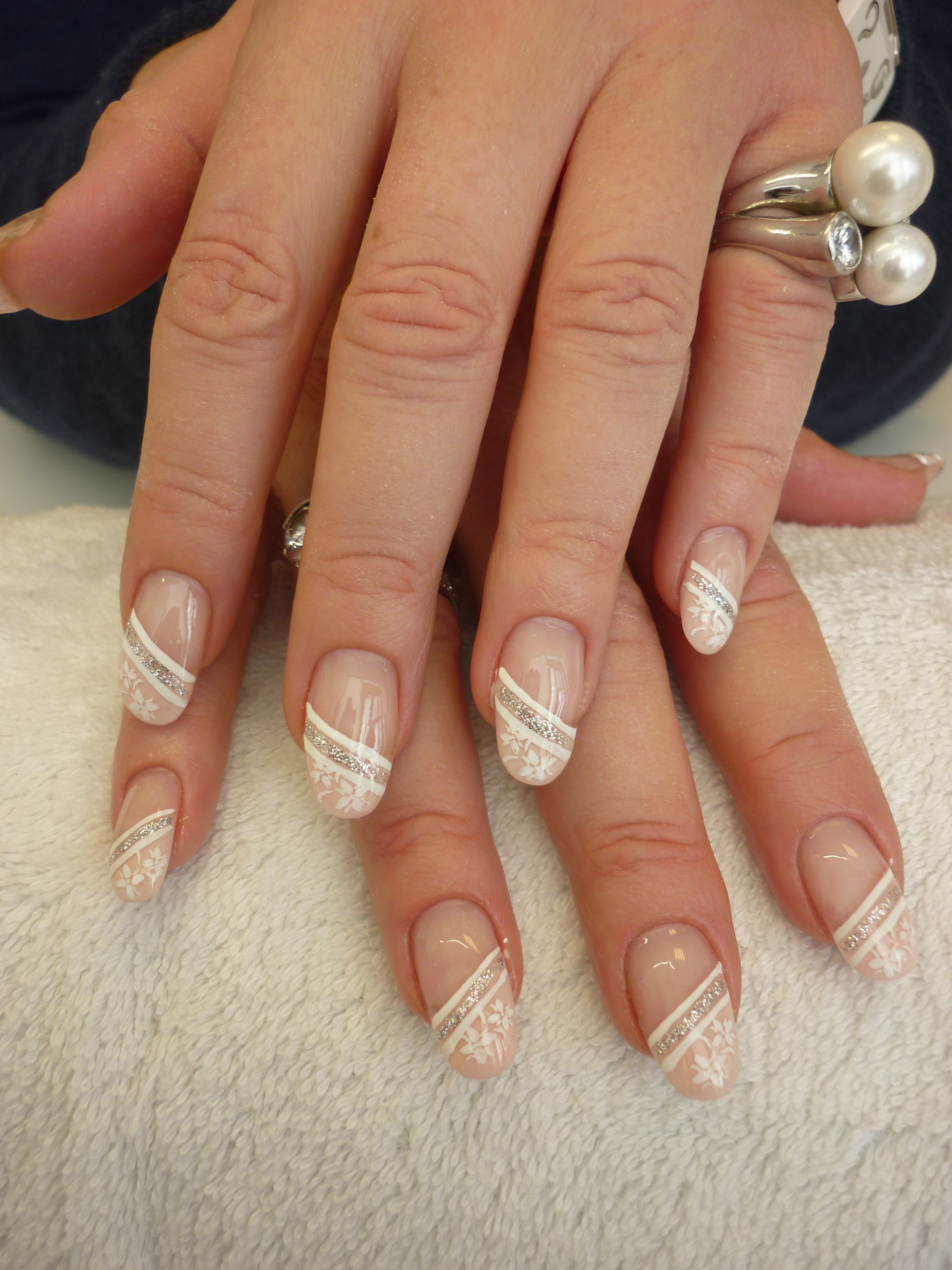 Eine Nahaufnahme der Nägel einer Frau mit einem Ring am Finger