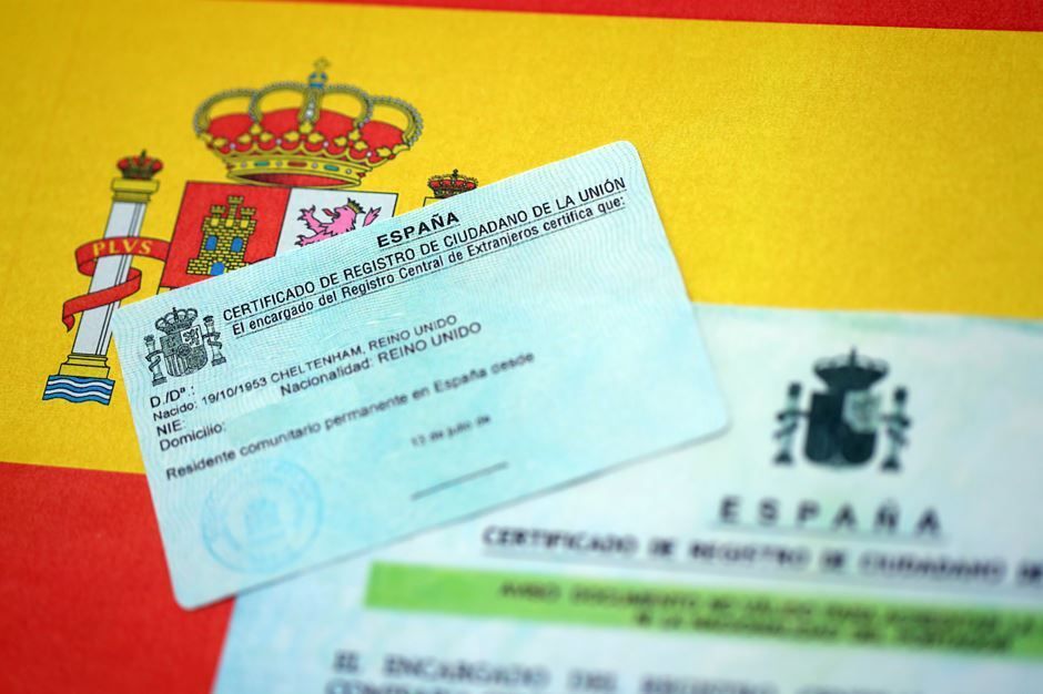 Tarjetas de identificación españolas con la bandera española como fondo.
