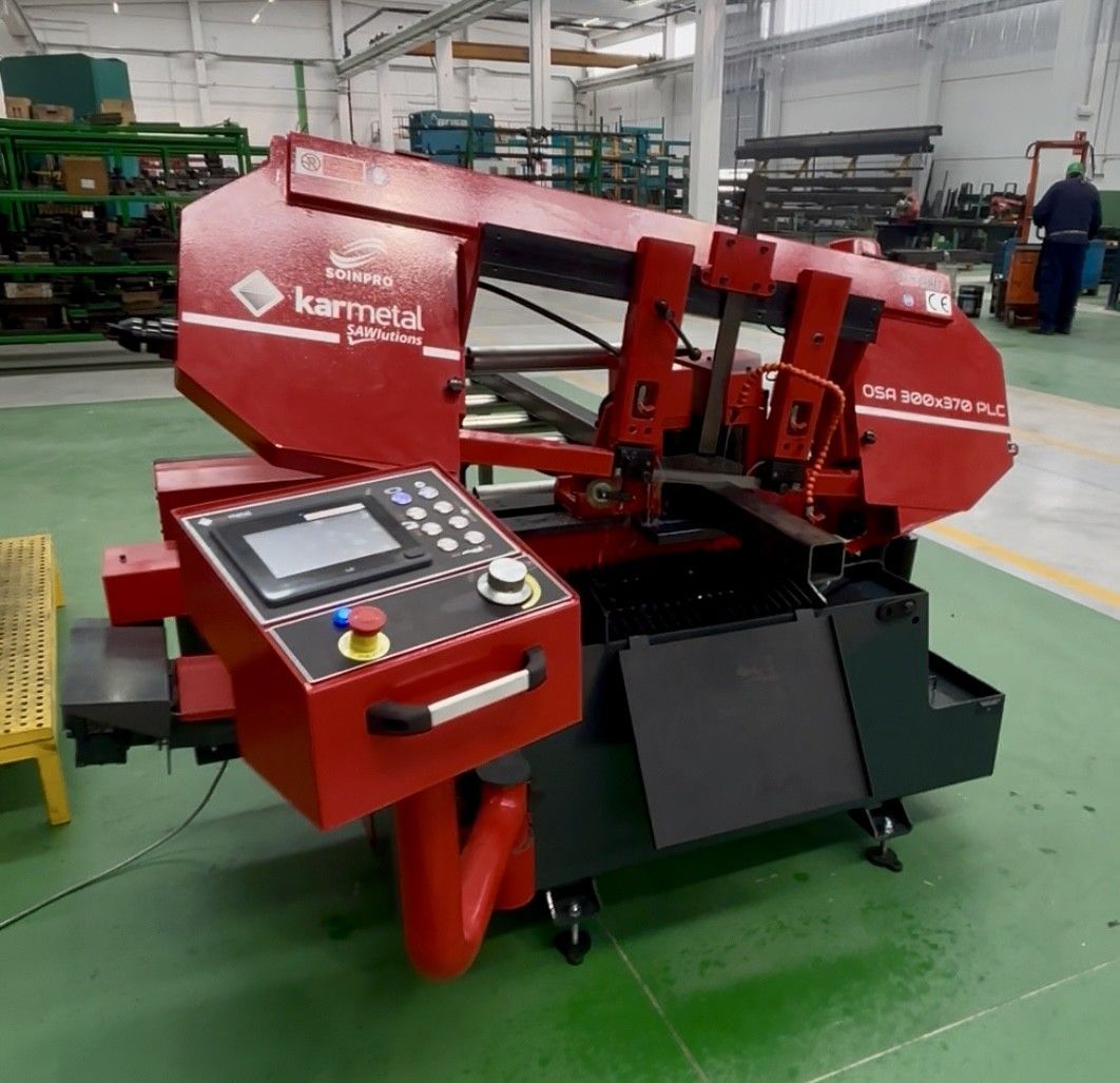 Una máquina roja y negra con una señal de advertencia amarilla.