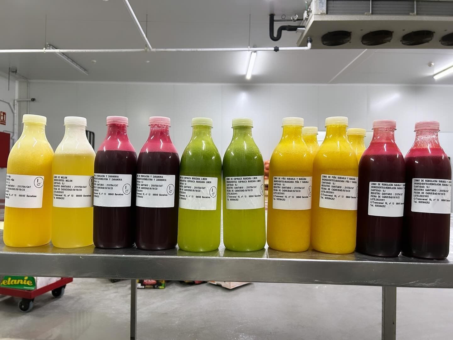 Varias botellas de jugo están alineadas en un estante