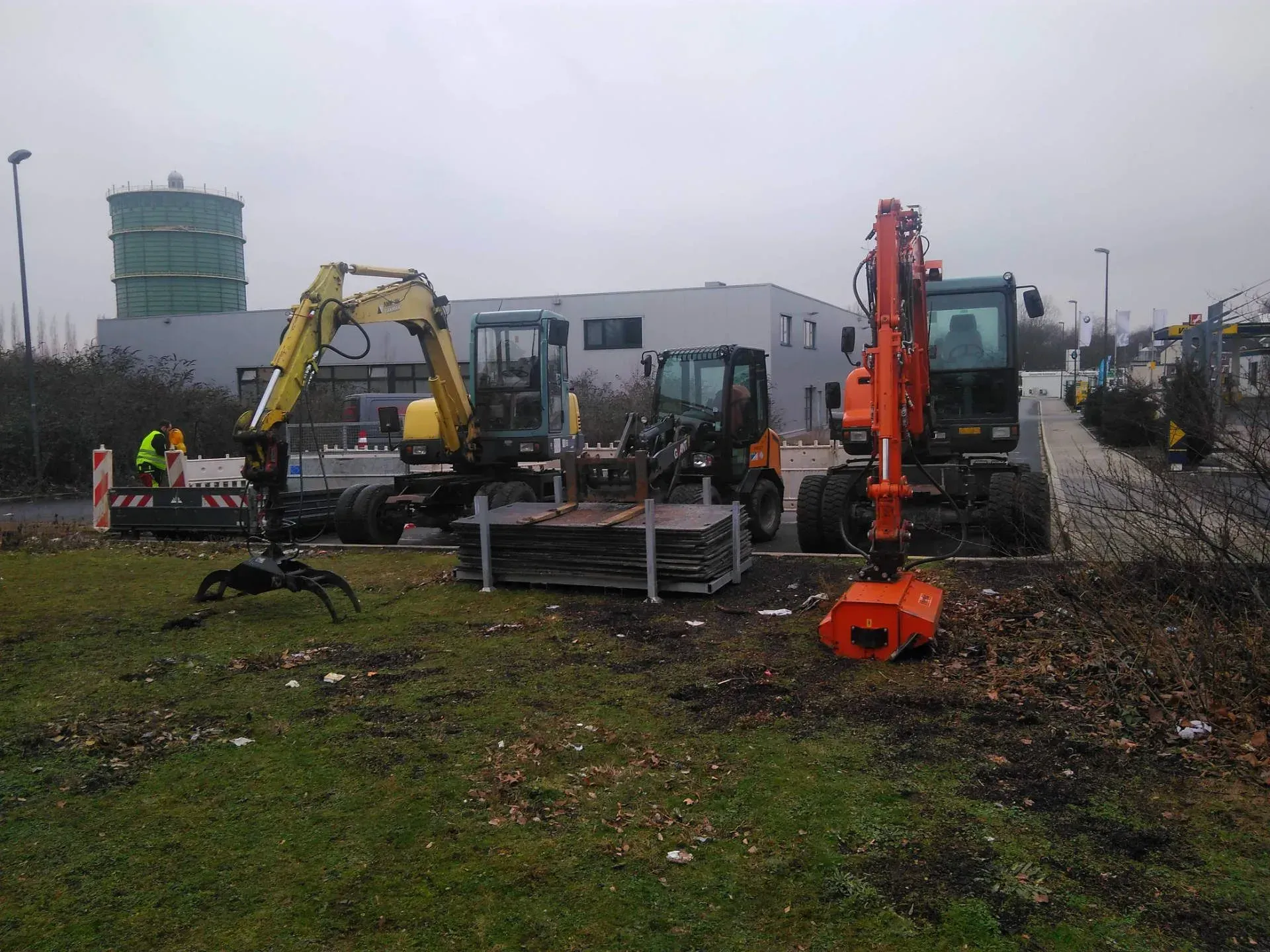 Eine Gruppe von Baufahrzeugen ist auf einem Feld geparkt.