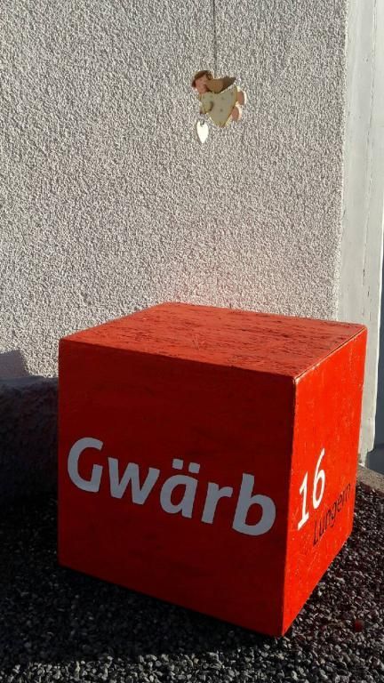 Drei Menschen im Kreis, Händchen haltend, meditieren auf Yogamatten. Natürliches Licht, neutrale Töne.