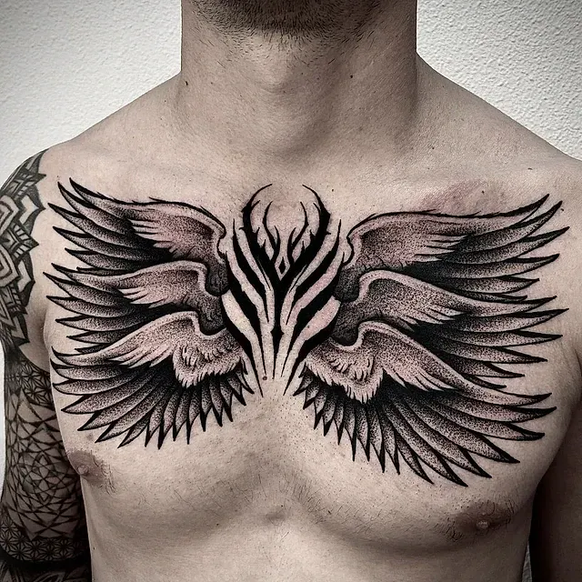 Un hombre tiene un tatuaje de alas en el pecho.