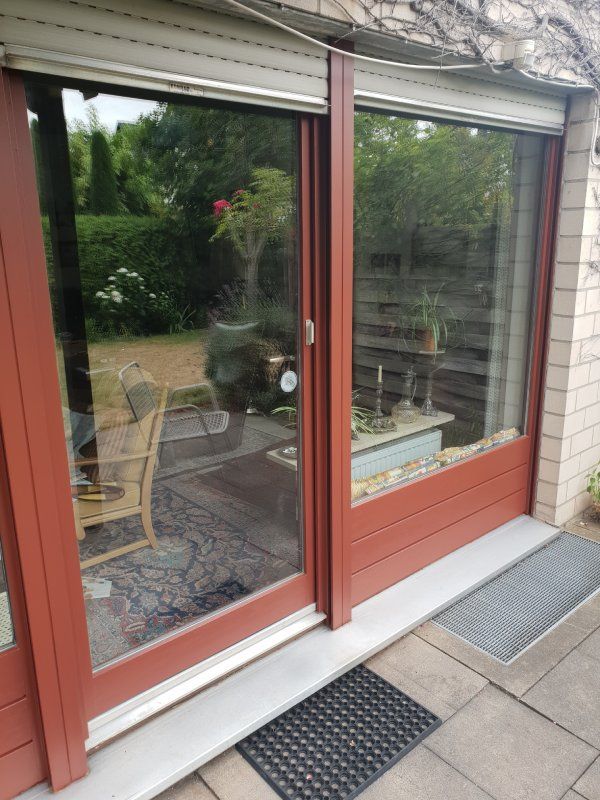 Eine Glasschiebetür führt auf eine Terrasse