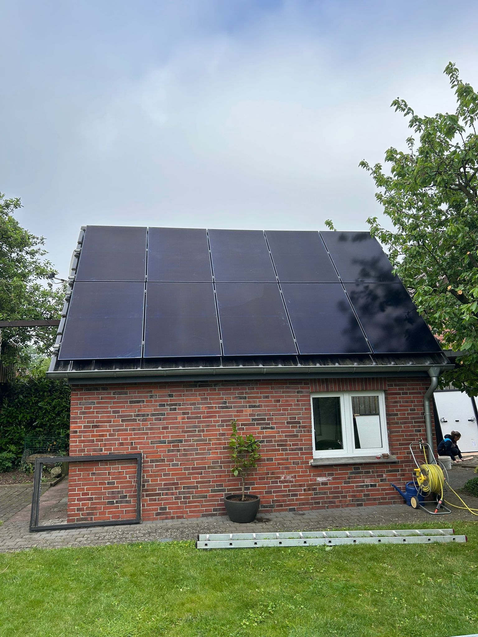 Ein Backsteinhaus mit Sonnenkollektoren auf dem Dach.