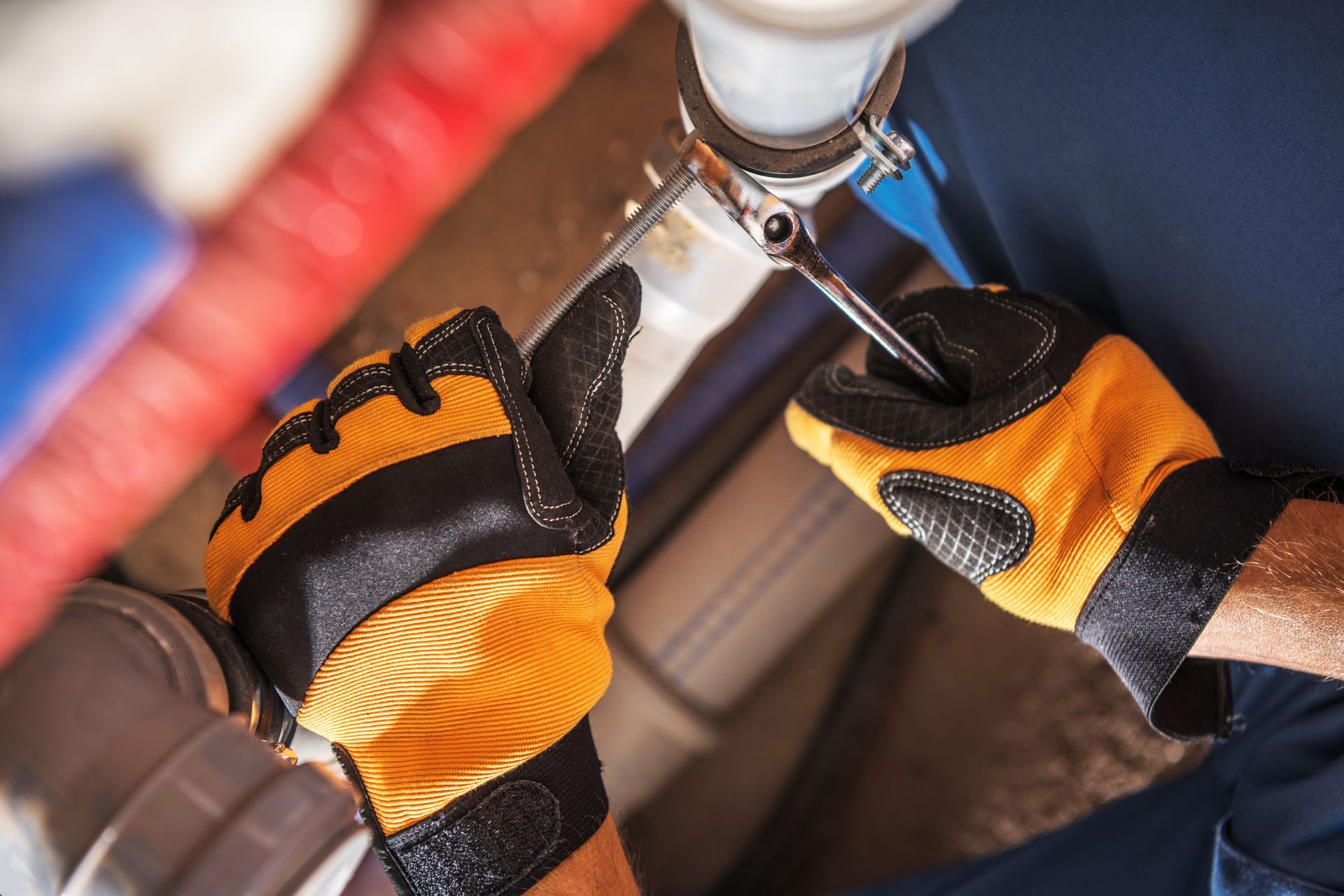 Deux mains en gants réparent un tuyau