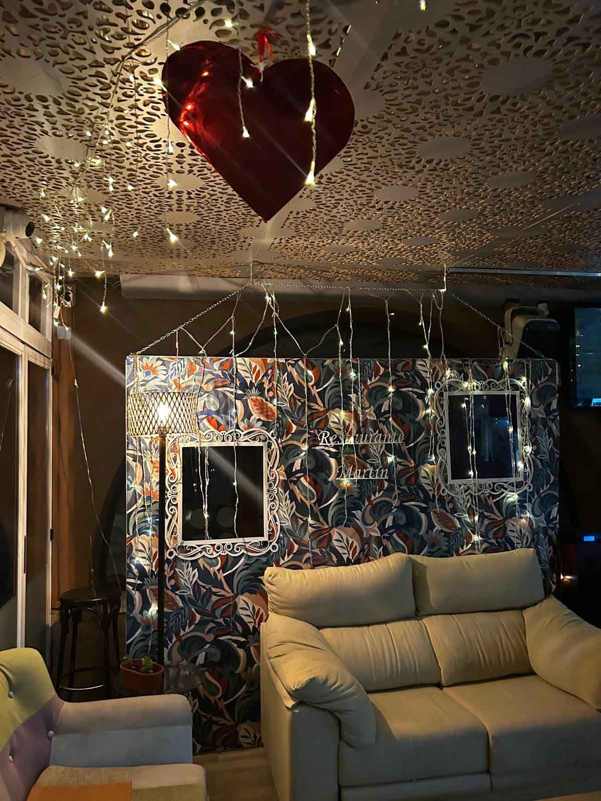 Una sala de estar con un globo en forma de corazón colgando del techo.