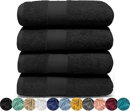 Cuatro toallas de baño negras apiladas, con una paleta de colores de otros colores de toallas debajo.