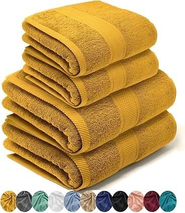 Cuatro toallas de baño amarillas dobladas y apiladas juntas, con muestras de color debajo.
