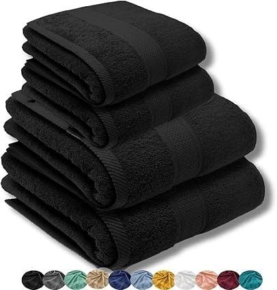 Juego de toallas negras, perfectamente apiladas; incluye toallas de baño y toallas de mano.