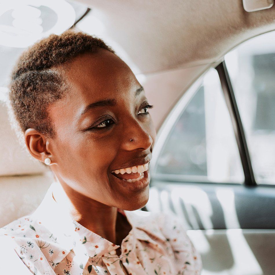 Femme souriante parlant au conducteur du taxi