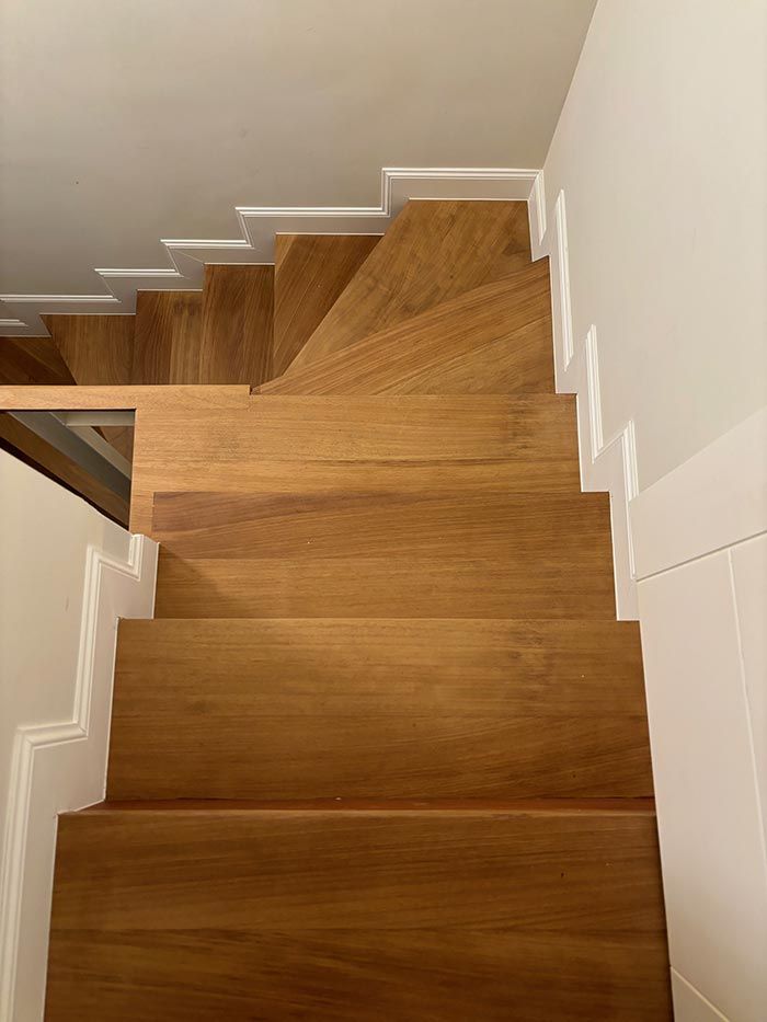 Un primer plano de una escalera de madera en una casa.