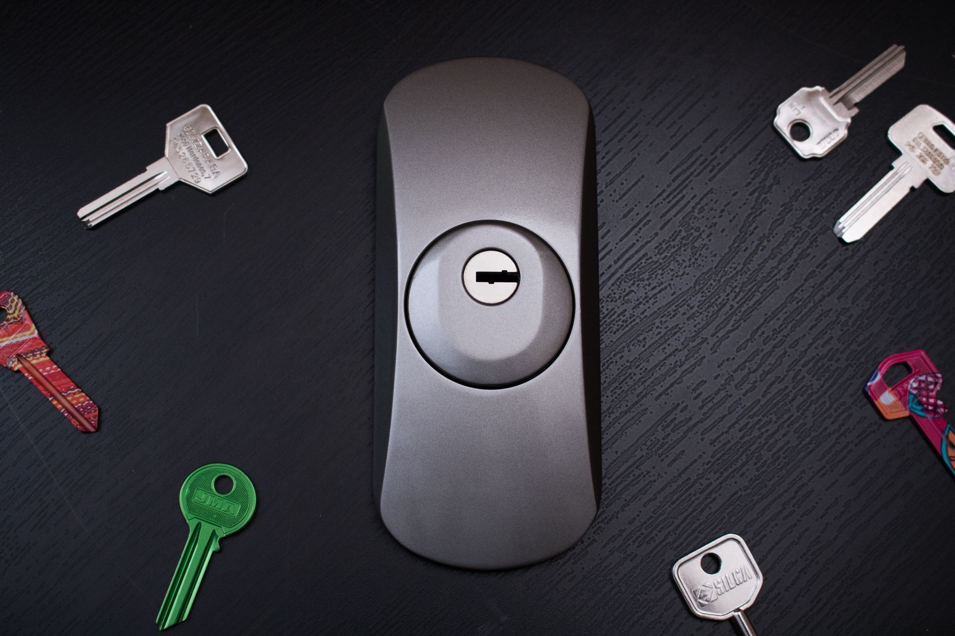 Hay un manojo de llaves alrededor de una cerradura sobre una mesa.