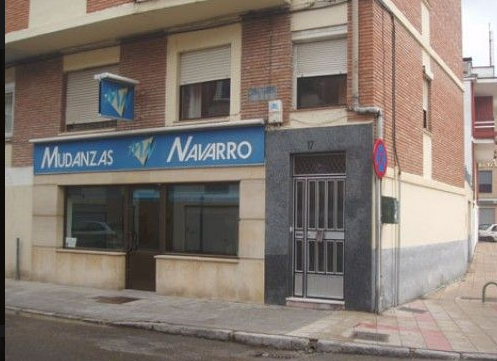 Un edificio con un cartel azul que dice mudanzas navarro