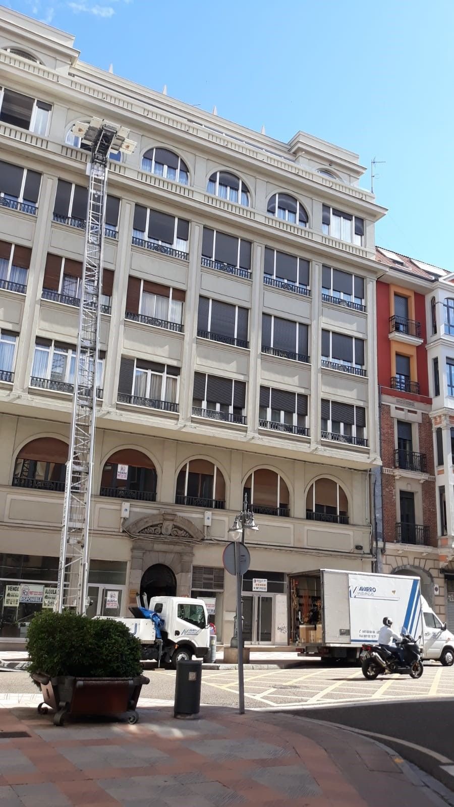 Un camión blanco está estacionado frente a un edificio grande.