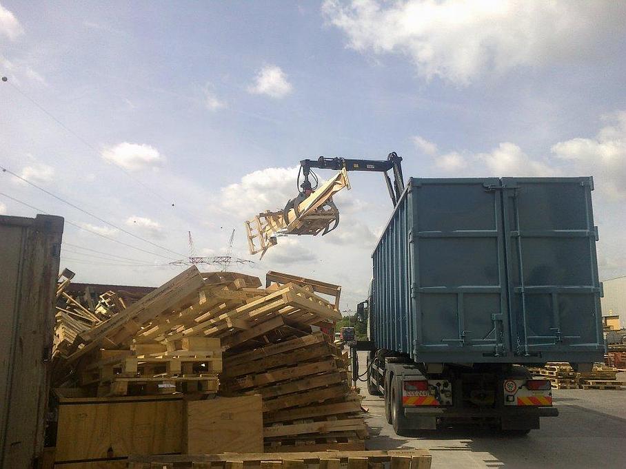 Camion-grue procédant à la collecte de déchets de bois