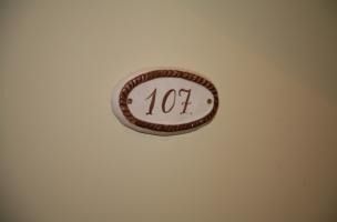 Un primer plano de un cartel con el número 107 en una pared.