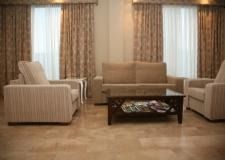 Una sala de estar con un sofá, sillas y una mesa de café.