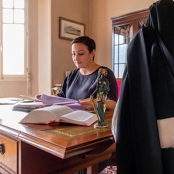 Maître Lorea CHIPI assise devant son bureau, lisant des papiers