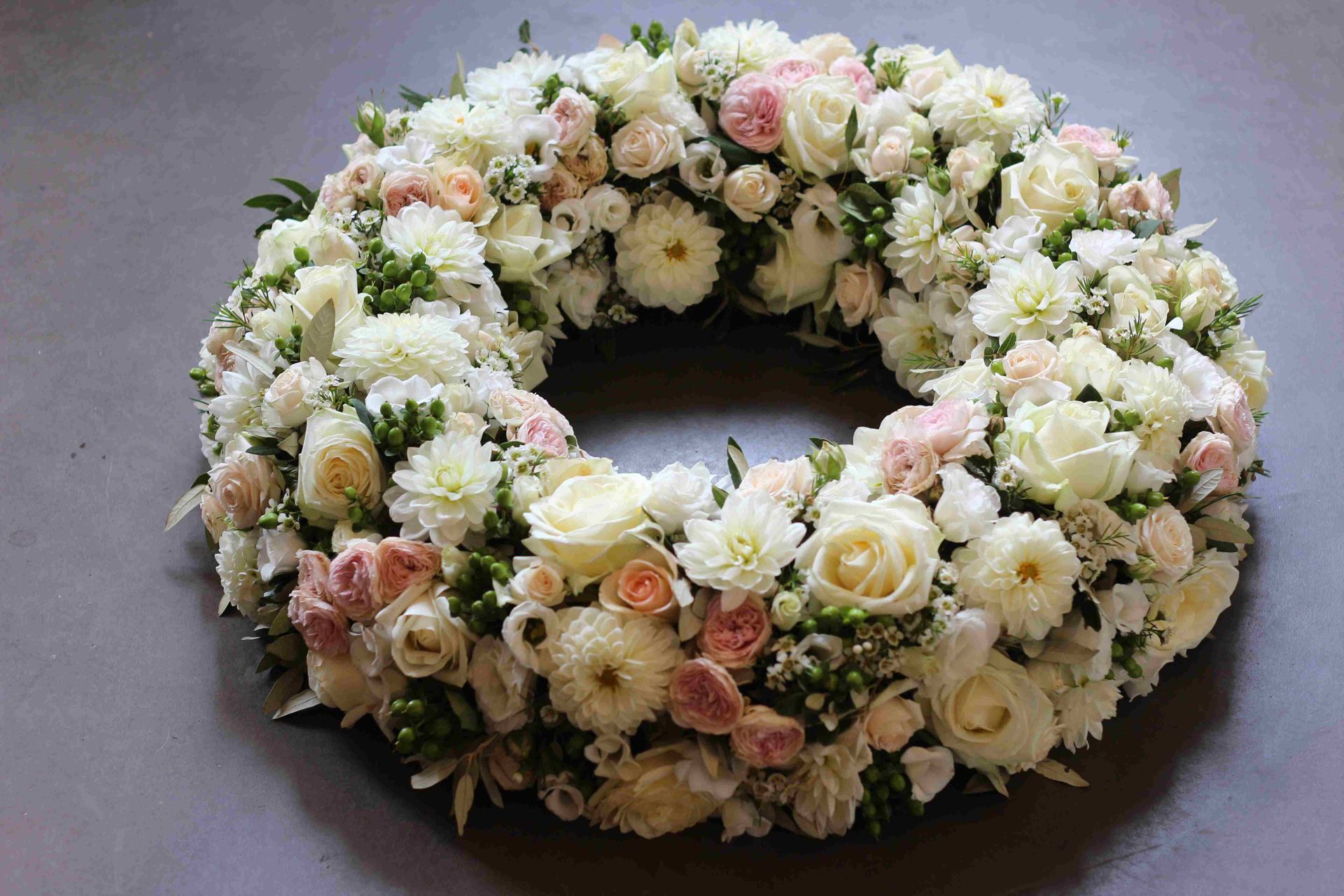 Blumenkranz mit weißen und rosa Rosen und Chrysanthemen.